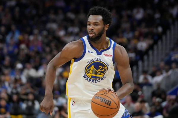 Golden State Warriors star Andrew Wiggins handles the ball.