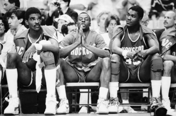 Houston Rockets Players, from left, Ralph Sampson, Mitchell Wiggins, and Akeem Olajuwon sit on the bench during the closing minutes of the teams 117-95 loss to the Boston Celtics in the NBA Playoff game at Boston Garden, Thursday, May 30, 1986, Boston, Mass.